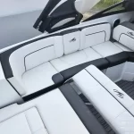 White and gray luxury boat seating with diamond quilting and logo embroidery, shown in a spacious cockpit area.