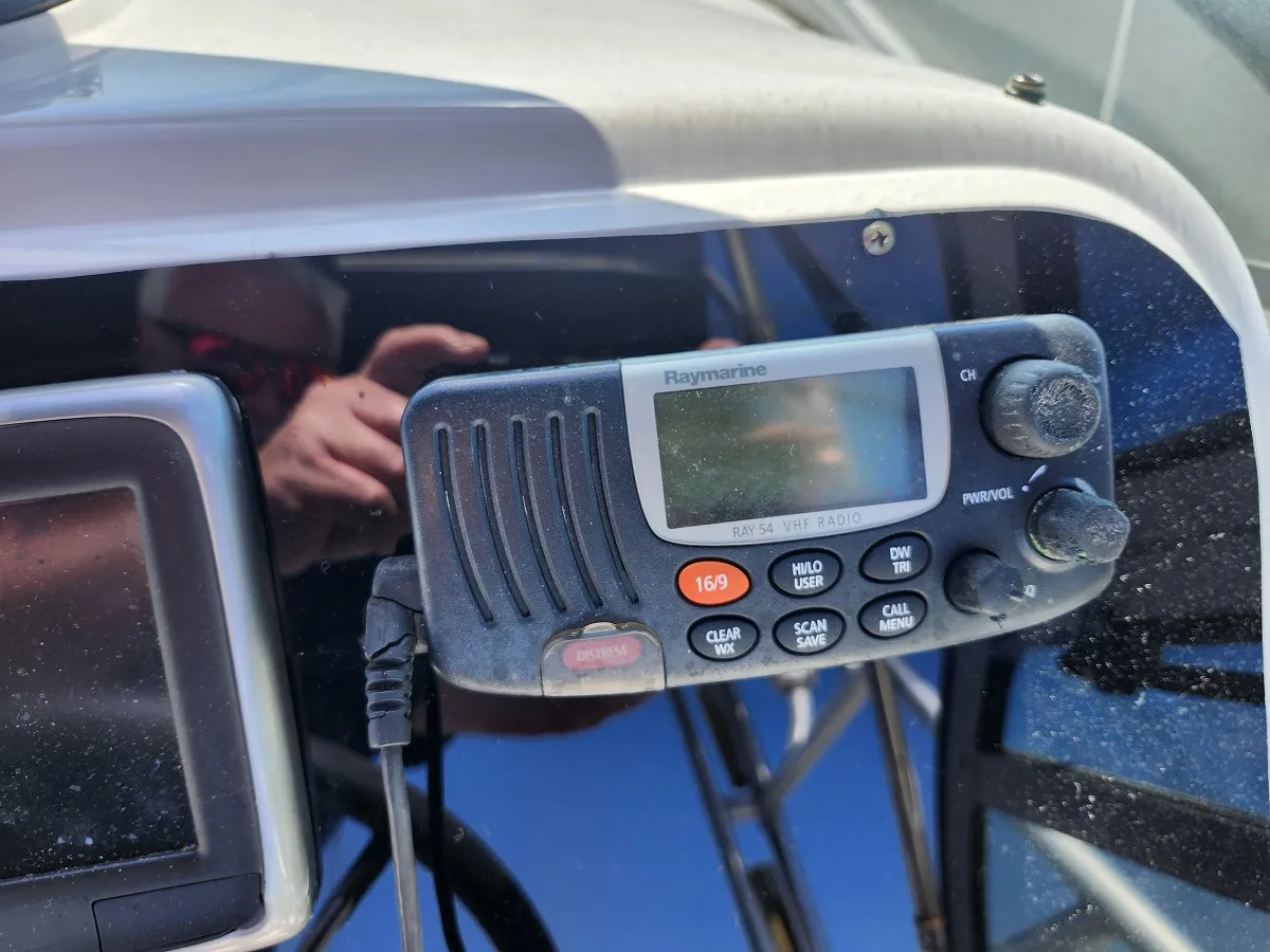 Raymarine VHF radio mounted on a boat dashboard with display and control knobs
