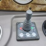 Grey boat thruster joystick on a worn dash, labeled ON-ON and OFF for bow thruster control (control panel).